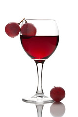 glass of red wine and grapes isolated