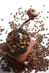 old-fashioned coffee grinder and roasted coffee beans isolated