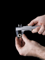 Measuring with caliper  tool  isolated over black background