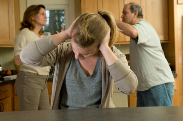 Teenage daughter covers ears while parents fight