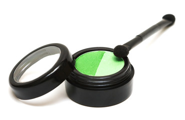 green make-up eyeshadows and cosmetic brush
