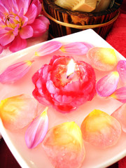 Spa essentials (candle on water and pink flowers)