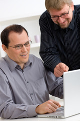 Businessmen using laptop computer