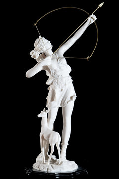 Classic white marble statuette of Artemis isolated on black
