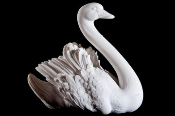 Classic white marble statuette of swan isolated on black