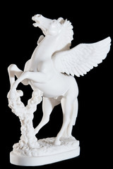 white marble statuette of bucking pegasus isolated on black