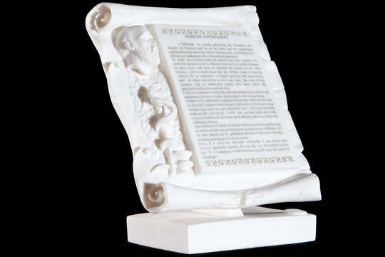 Classical white marble Hippocratic Oath isolated on black