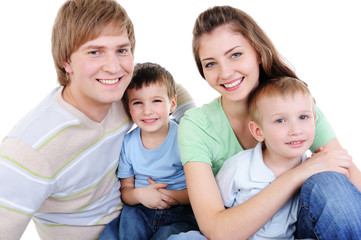 Obraz premium happy young family with two little sons