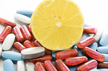 pills and lemon isolated on white bacground