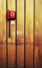 Retro phone on a wooden wall