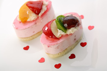 Cheesecake with fresh fruits on orange background