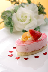 Cheesecake with fresh fruits on orange background