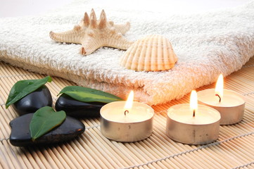 foldet white bath towel and zen stones