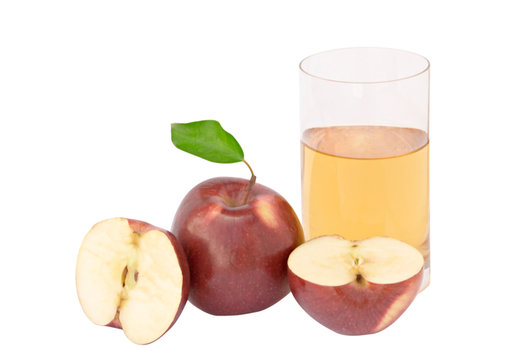 Glass of natural apple juice and sections of apple