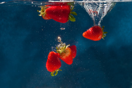Strawberries dropped into water