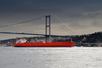 ship under Bosphorus bridge before the storm - Powered by Adobe