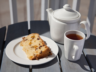 Delicious cake with tea on a patio