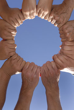 Several hands holding together in a circle