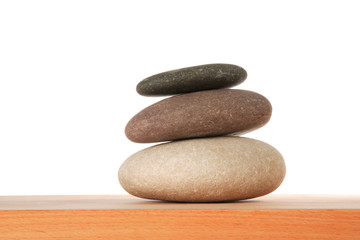 Fototapeta na wymiar Three multi-coloured rocks stacked in balance