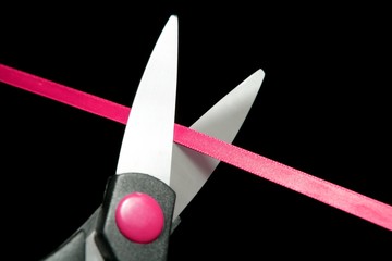 Red tape going to be cutted by scissors