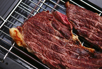 juicy roast meat on black bbq