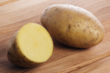Potato on a wooden kitchen board