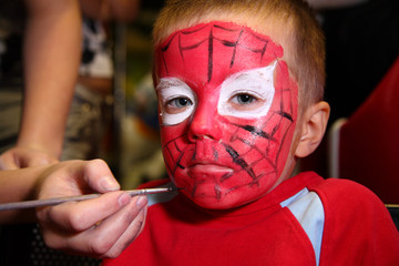 boy painted as spiderman