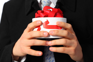 Businessman with gift box in hands