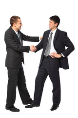 Two young businessmen greet