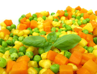 Cooked vegetables with basil leaves
