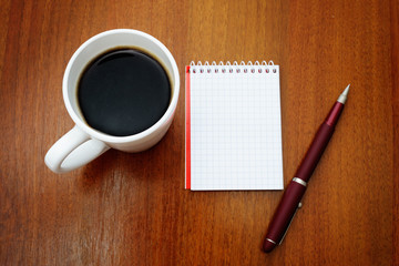 Pen, notebook and coffee