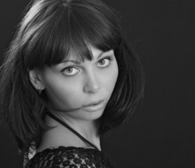 Young beautiful woman on black background