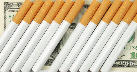 the cigarettes laying on american money