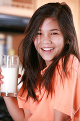 Child holding glass of milk