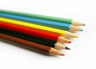 rainbow colored crayons on white isolated