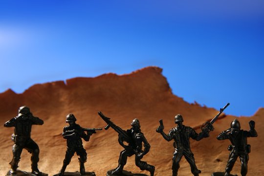 plastic toy soldier over wooden mountain