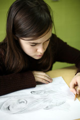Girl drawing using pencil