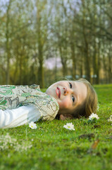 girl relaxing on grass in park.