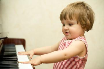 Little girl plays piano