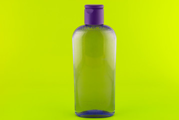 cosmetic container on a green background