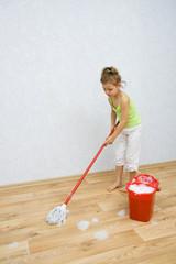 Little girl cleaning the floor