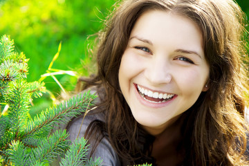 Beautiful girl on the grass in sunny day