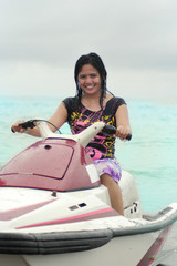 Woman ride Jetski smiling at beach