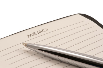 Notepad and pen on white background