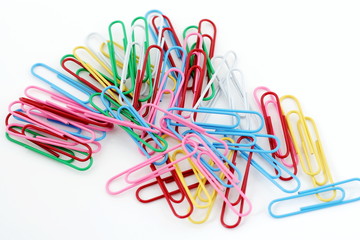 colored paperclips on white background