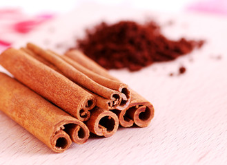 cinnamon stick and coffee on wooden plate