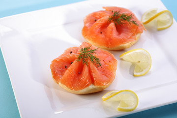 Smoked salmon on bagel with fresh black pepper.