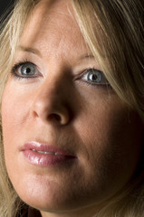 blond woman head shot with smile and in thought