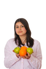 Young girl with apples and oranges