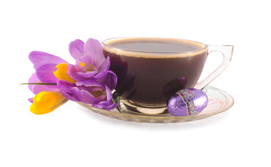 Cup of coffee with chocolate easter egg and fresh crocuses